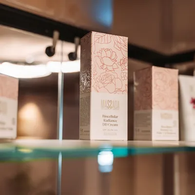 Massada Biocellular Radiance DD Cream SPF 25 displayed on a glass shelf